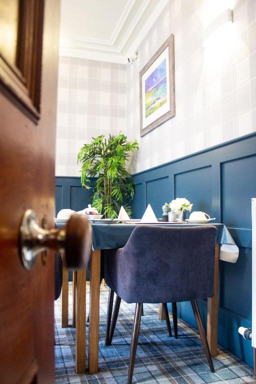 a table and chairs in a room with a door at Kintrae B&B in Buckie
