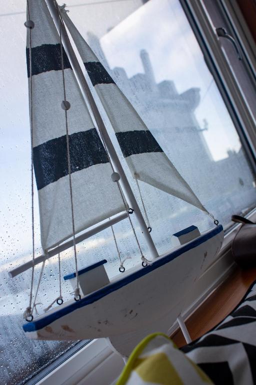 a small sail boat sitting in a window at Kintrae B&B in Buckie