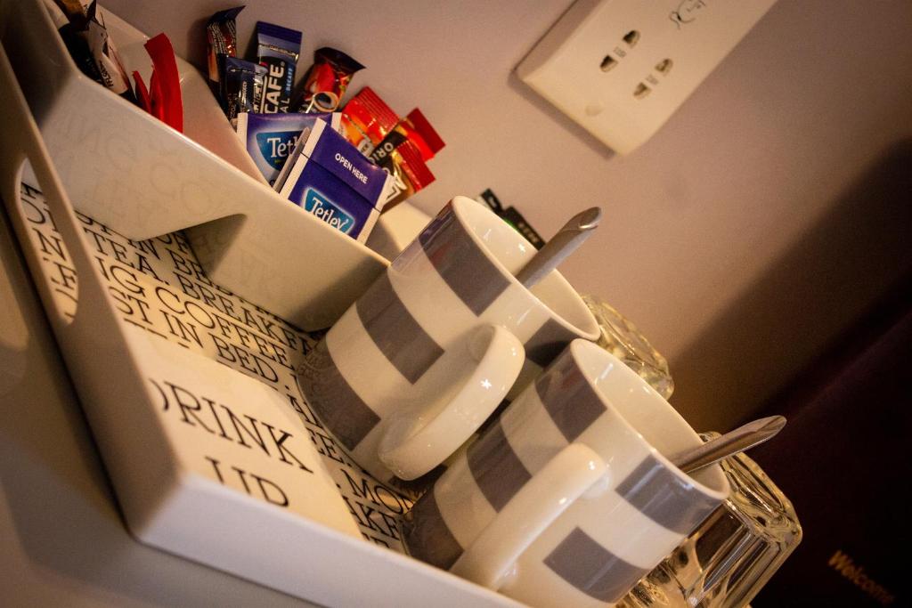a group of mugs sitting on top of a refrigerator at Kintrae B&B in Buckie