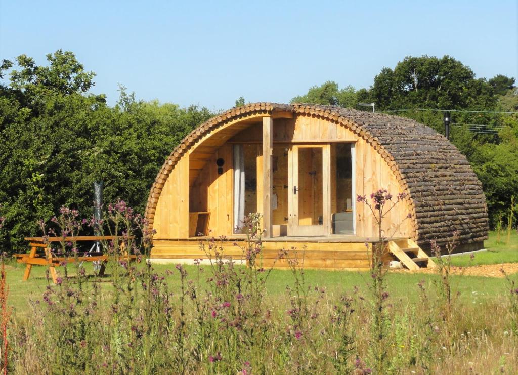 a circular house with a large stone roof at Cosy Cabins at Westfield Farm in Yarmouth