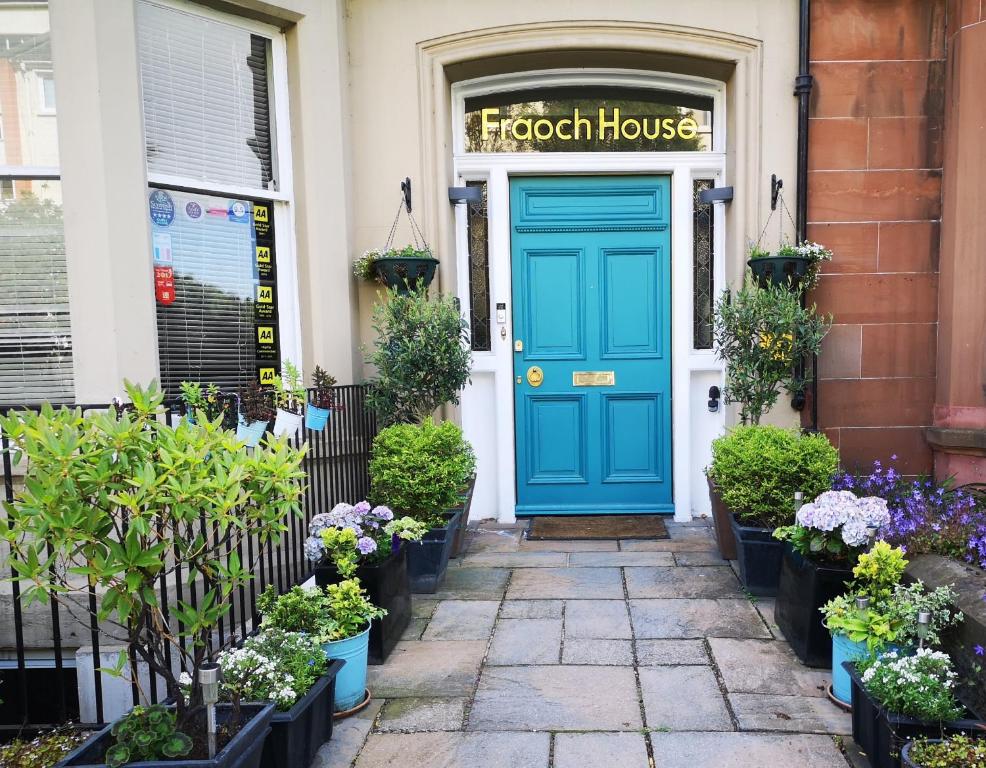 a blue front door of a house with plants at Fraoch House in Edinburgh