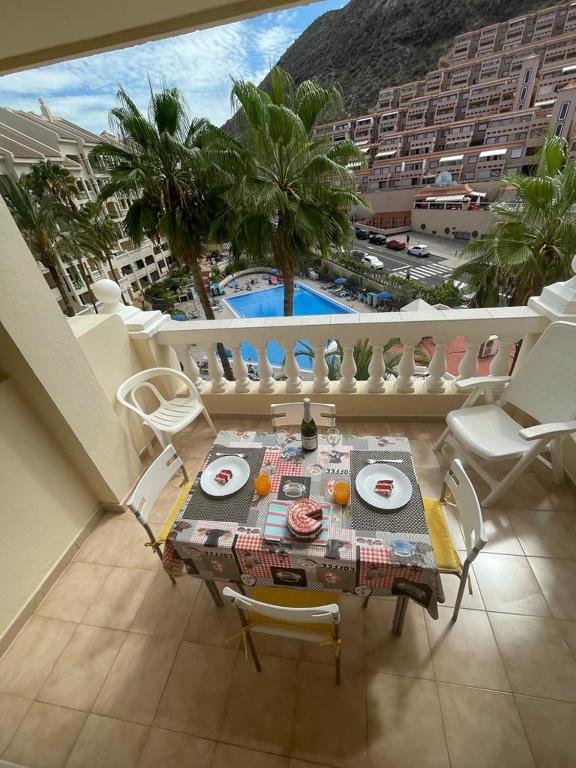 a room with a table and chairs on a balcony at DORY HOUSE LOS CRISTIANOS in Los Cristianos