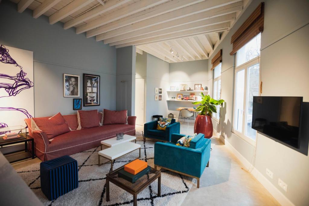 a living room with two couches and a tv at Oever House in Antwerp