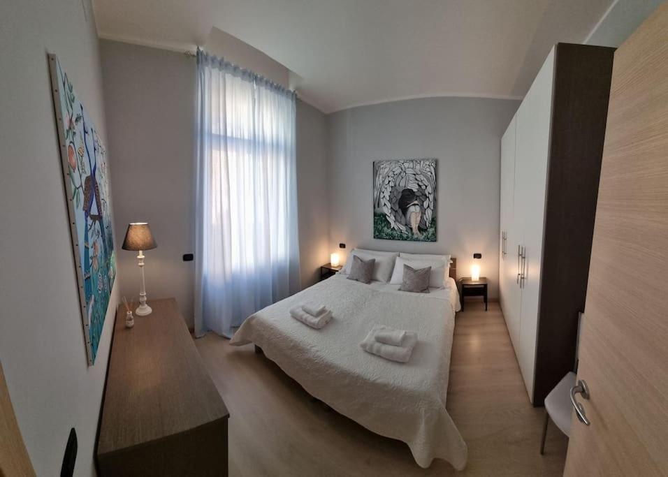 a bedroom with a large bed with two towels on it at Apartments via Roma in Rovereto