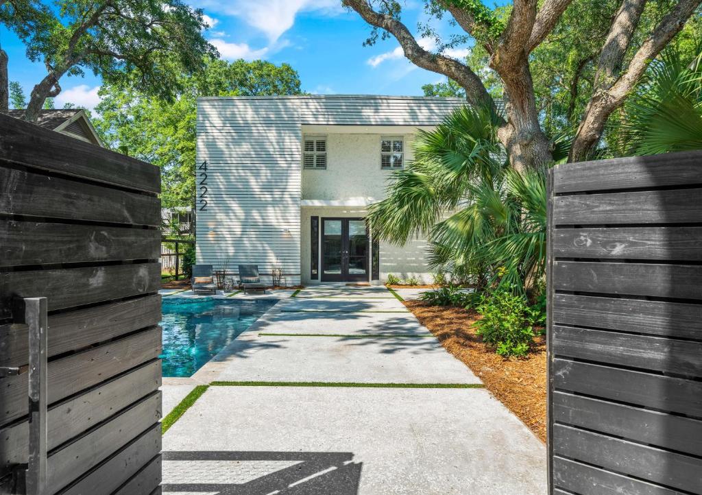 a house with a swimming pool and a fence at Zen-N-Sea - 4222 Third St in Saint Simons Island
