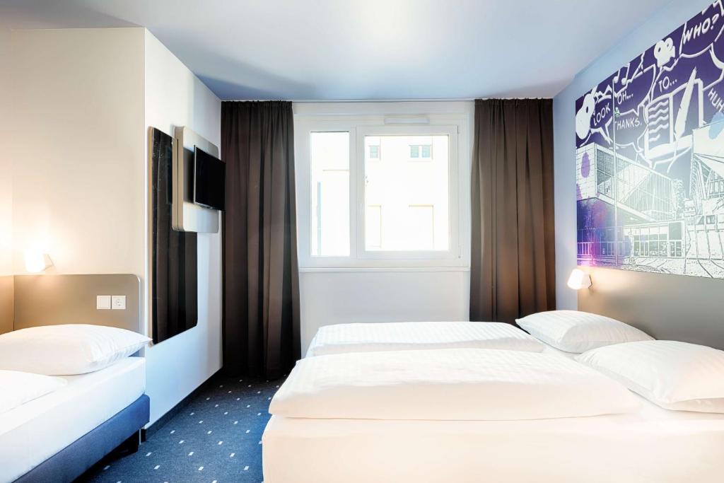 Łóżko lub łóżka w pokoju w obiekcie B&B Hotel Wien-Stadthalle