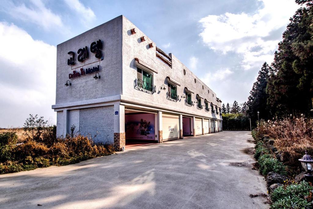 a white building with the word opera on the side at Gyorae Drive-in Motel in Jeju