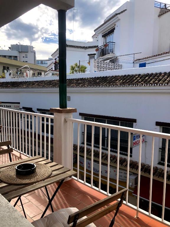 a balcony with a table and chairs and a building at Bajondillo Beach Apartment By Torremolinos On-line in Torremolinos