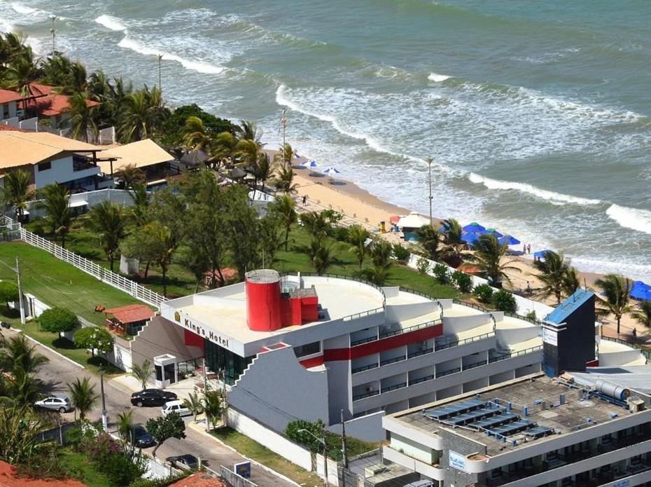 a building next to a beach with the ocean at KING's FLAT HOTEL NATAL in Natal