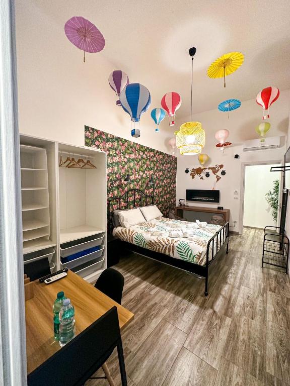 a bedroom with a bed with umbrellas on the wall at Kofler GuestHouse in Barletta
