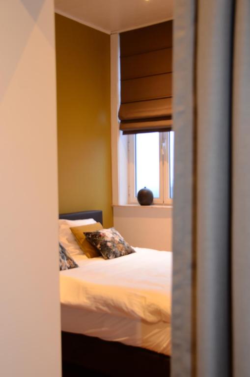 Postel nebo postele na pokoji v ubytování Boeckhaege vakantiewoning