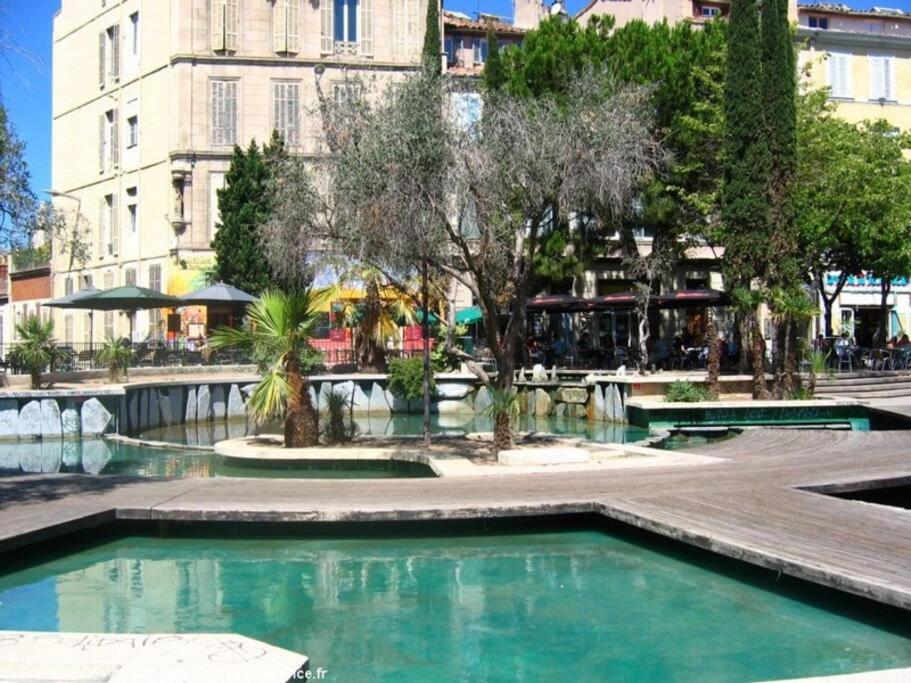 a pool of water in the middle of a city at Studio au coeur de Marseille in Marseille