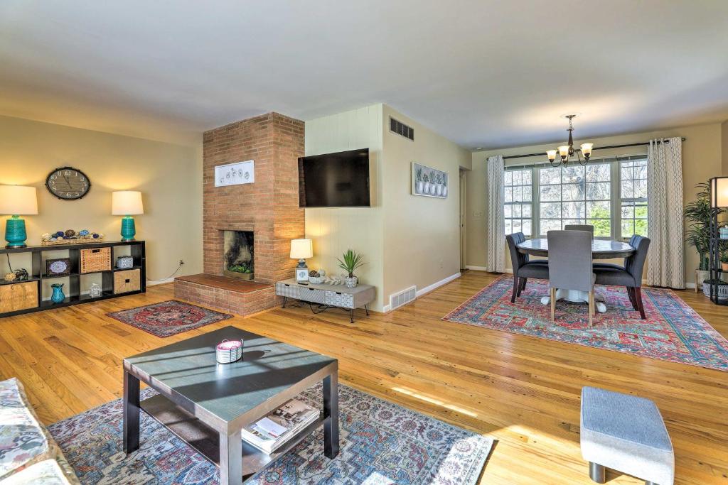 a living room with a table and a fireplace at Cincinnati Vacation Rental 5 Mi to Downtown! in Cincinnati