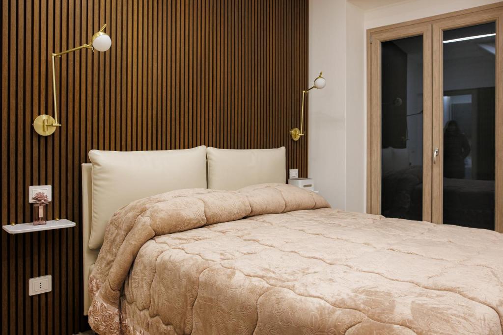 a bedroom with a large bed with brown stripes at Next To Sea in Crotone