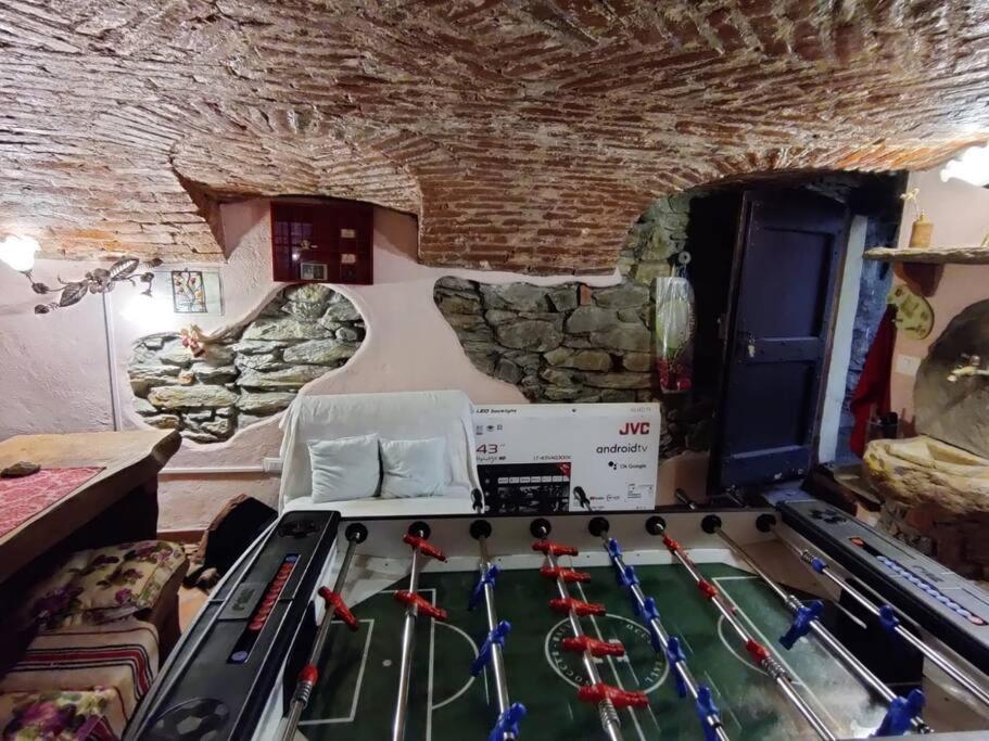 a room with a pool table in a cave at The Golden Eagle - Chalet a Champdepraz in Aosta