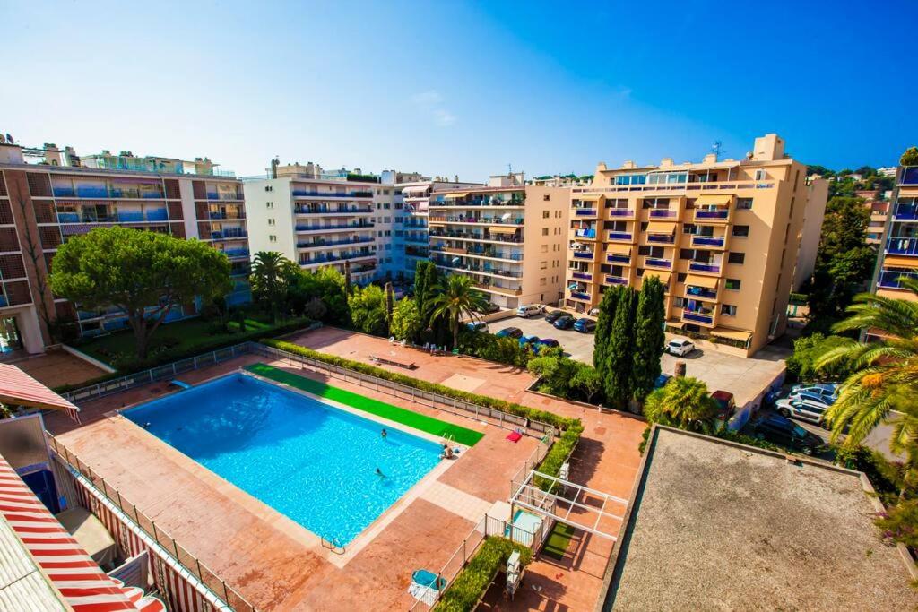 an overhead view of a swimming pool in a city at French Riviera: Seafront apt & pool near Monaco in Roquebrune-Cap-Martin