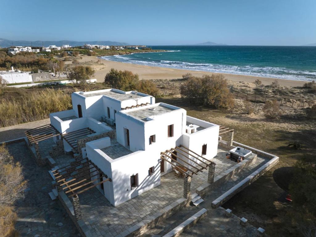 an aerial view of a white house and the beach at Golden Beach Villa Paros in Chrissi Akti