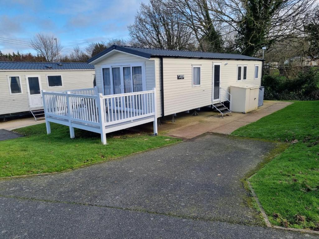 a mobile home with a blue bench in a yard at "Malton" LG27 Pet Friendly in Shanklin