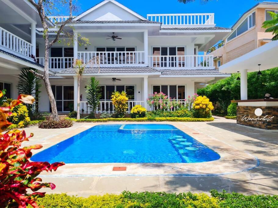 uma casa com piscina em frente a uma casa em Fiorella Beach House, Diani Beach em Praia de Diani