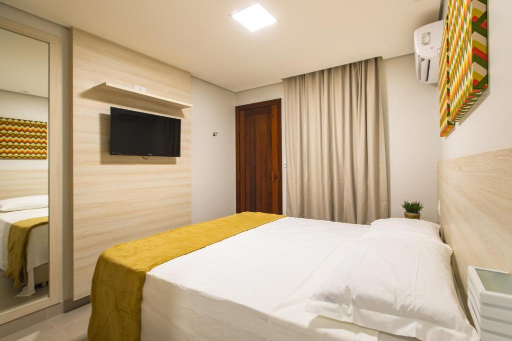 Postel nebo postele na pokoji v ubytování Hotel Encantos de Itaperapuã