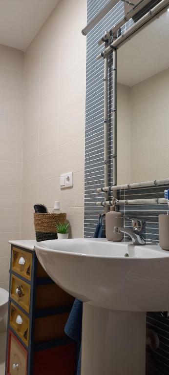 a bathroom with a white sink and a mirror at Apartamento Cerezo Beach in Xilxes