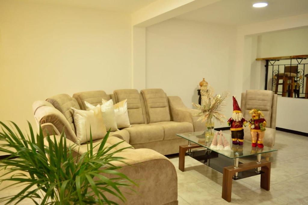 a living room with a couch and a glass table at Hostal Sol Naciente in Alcalá