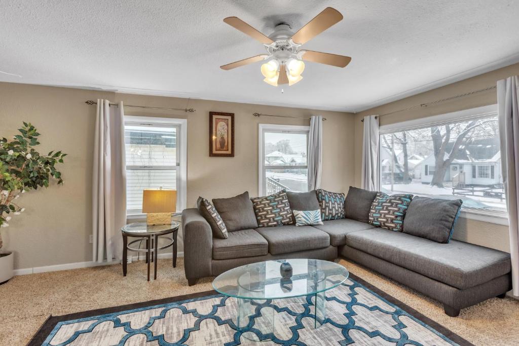 uma sala de estar com um sofá e uma ventoinha de tecto em Lovely PET FRIENDLY three bedroom in desirable Urbandale Location! home em Wyoming