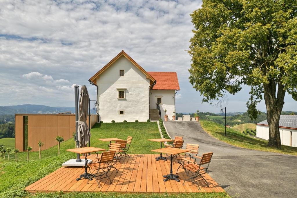 a group of tables and chairs in front of a building at Hisa 1624 - Adults Only in Zgornja Kungota