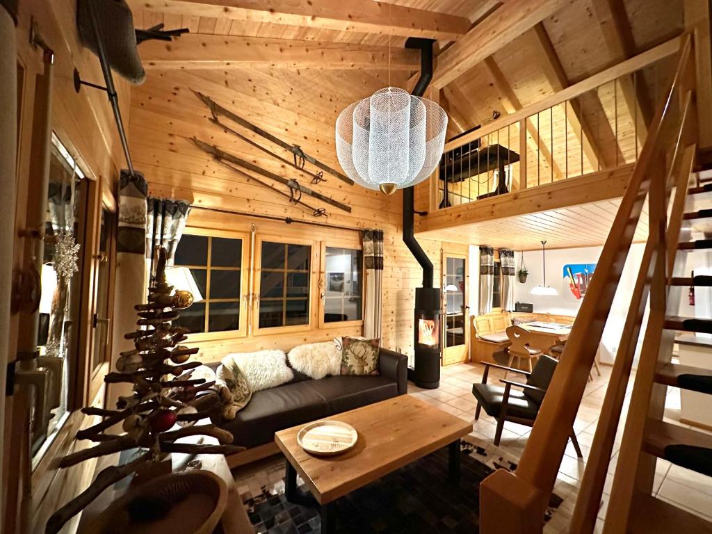 a living room with a couch and a table at Chalet Chumma Galeriewohnung in Riederalp
