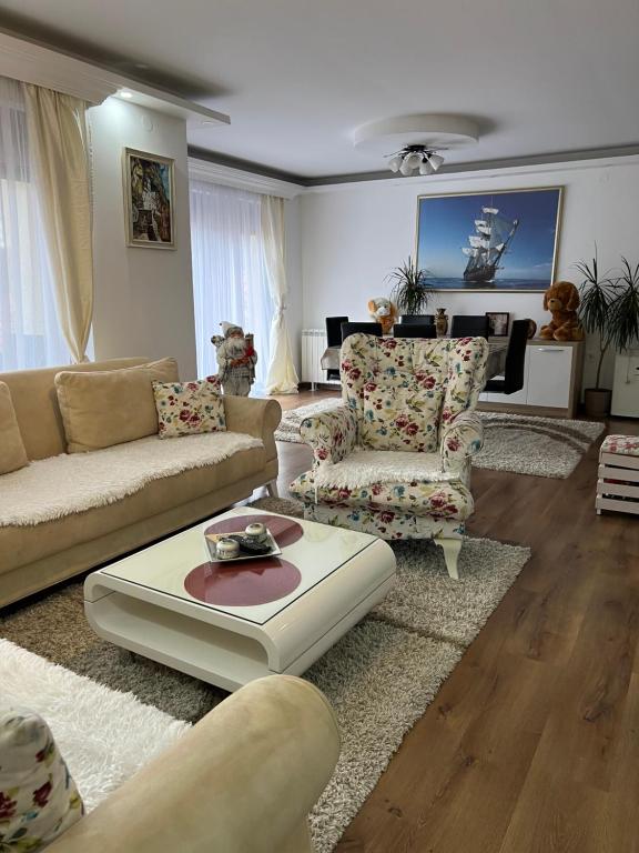 a living room with two couches and a coffee table at Montana House Njeguši in Cetinje