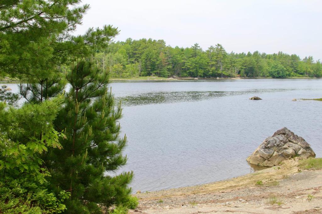 a large lake with a rock in the middle at 1 and Only Riverside Accommodations in Sable River