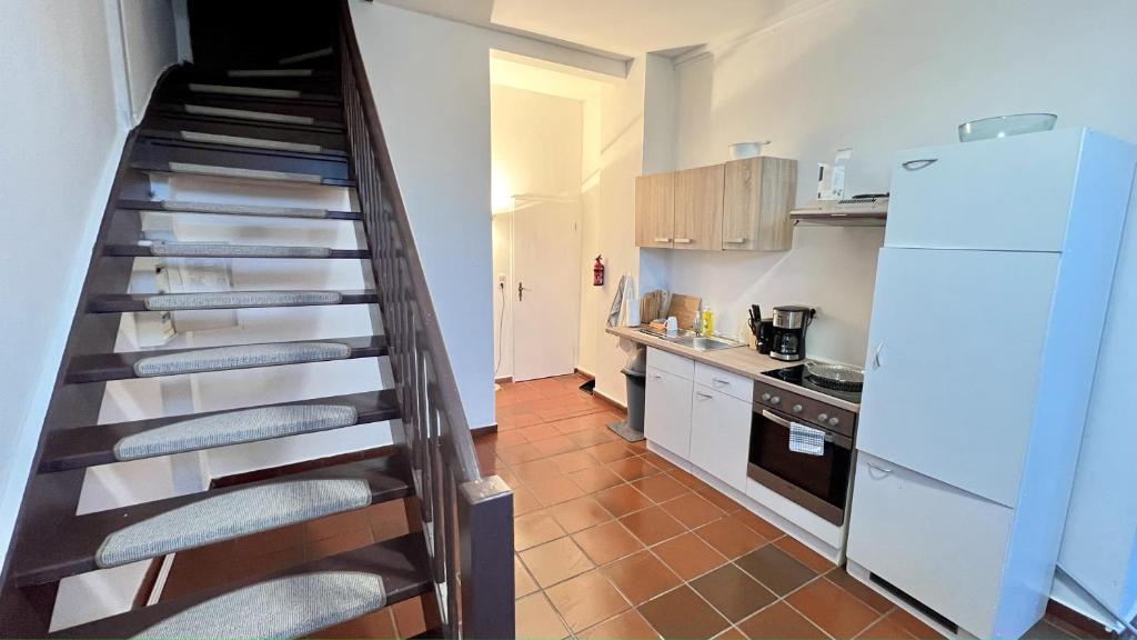 a kitchen with a spiral staircase in a kitchen at Monteurwohnung Brunsbüttel zentrale Lage mit Parkplatz & Schleusenblick in Brunsbüttel
