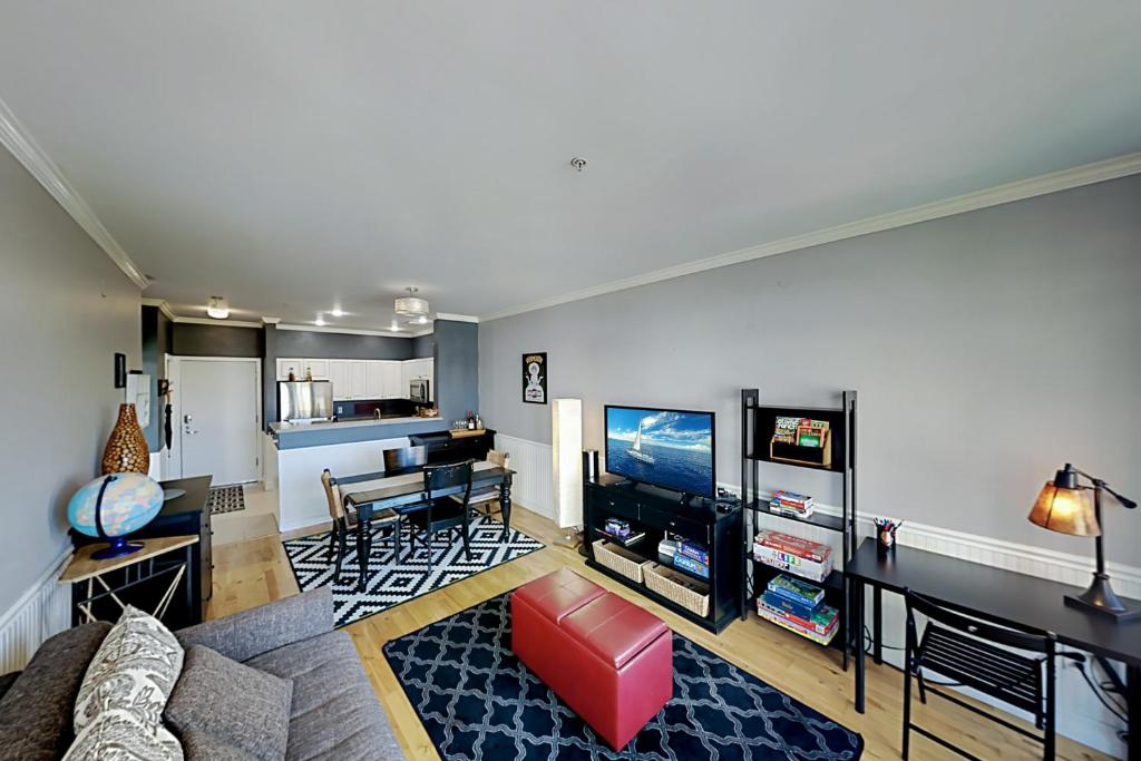 a living room with a couch and a tv at Cityscape Dreams in Seattle