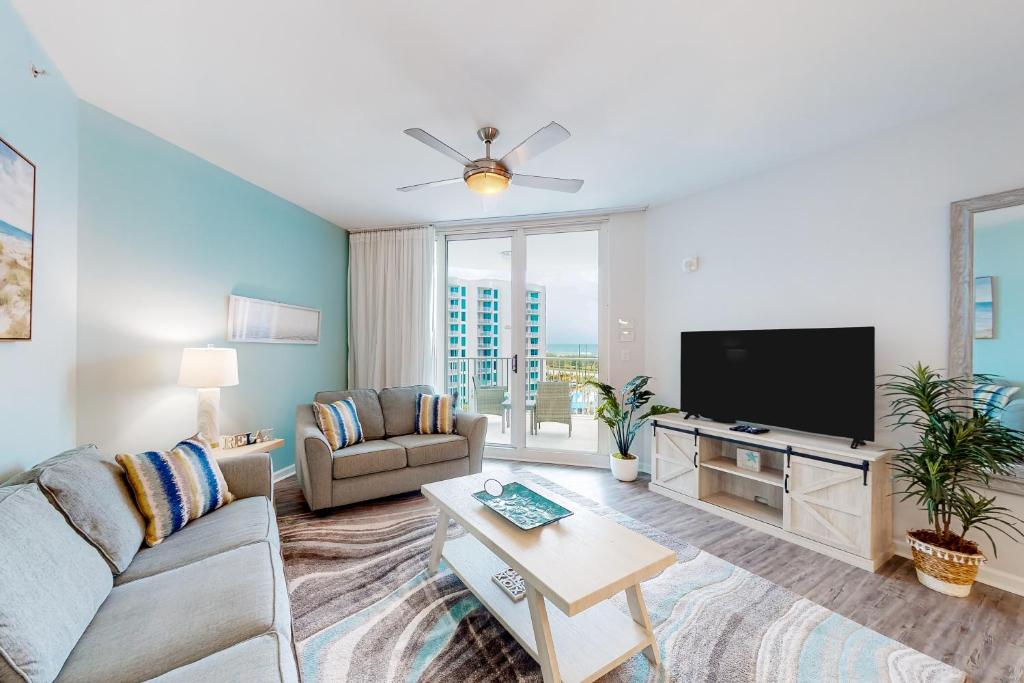 a living room with a couch and a tv at Palms of Destin 2803 in Destin