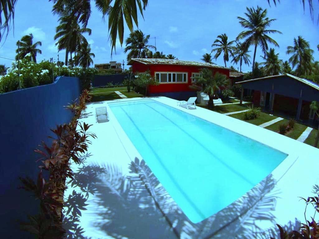 a swimming pool in front of a house at Casa Colorida in Pipa