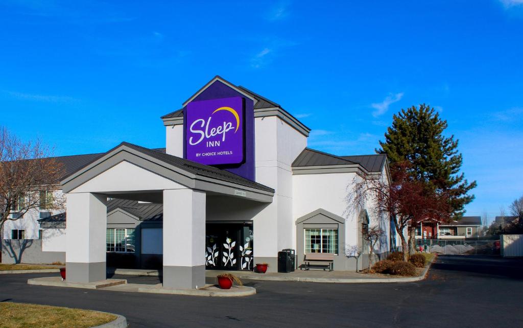 a store with a purple sign on top of it at Sleep Inn in Bend