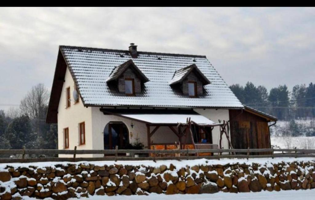 a house with a bunch of animals in front of it at Dom w sercu Kaszub in Parchowo