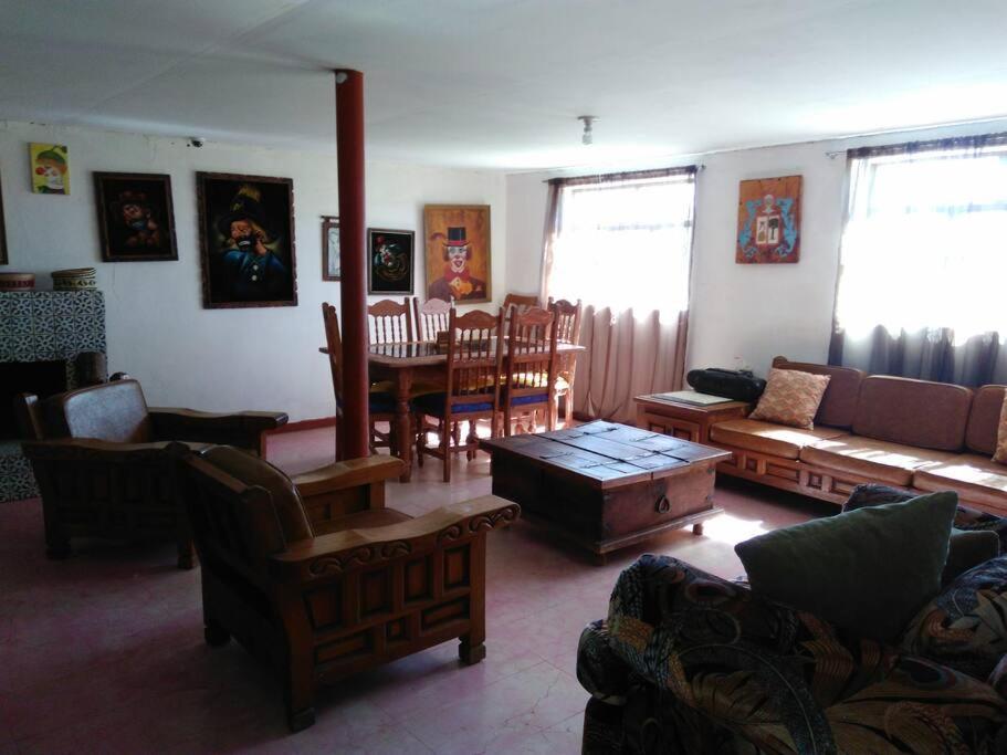 uma sala de estar com um sofá e uma mesa em Beautiful Rustic Cottage Adobe, Rancho El Payasito em Cuauhtémoc