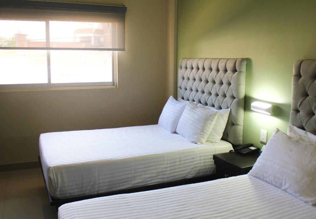 Postel nebo postele na pokoji v ubytování Hotel Mirage