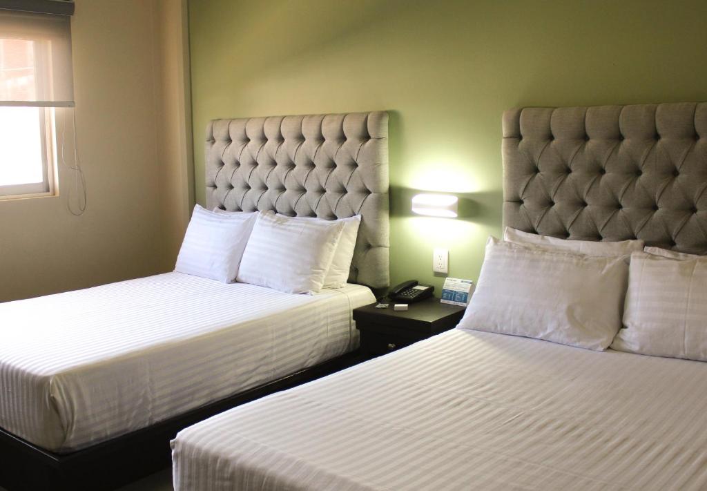 Postel nebo postele na pokoji v ubytování Hotel Mirage