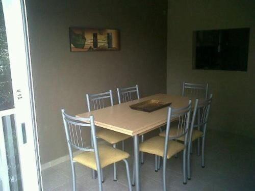 a dining room table with chairs and a table and a table and chairsktop at Arenas 497 in Pinamar