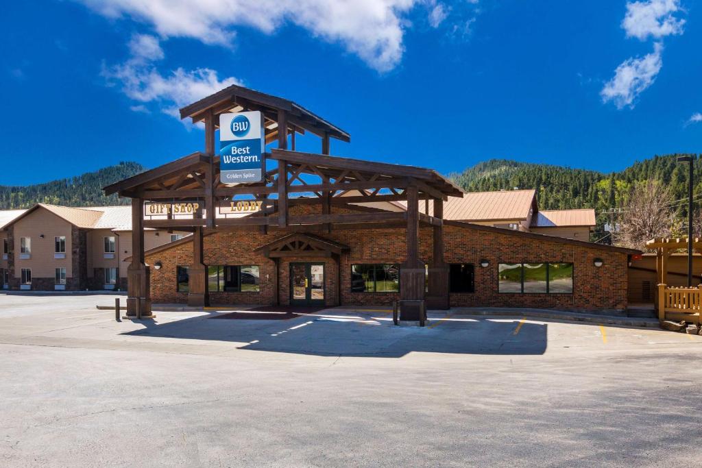 a gas station with a sign on top of it at Best Western Golden Spike Inn & Suites in Hill City