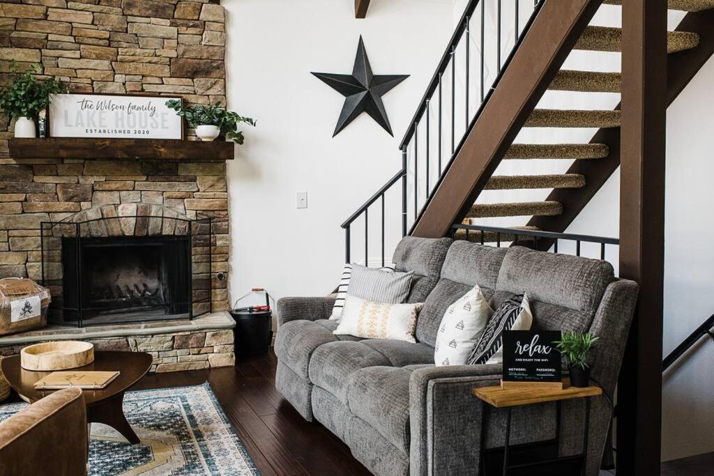 a living room with a couch and a fireplace at Little Chip Lake Arrowhead Cabin in Lake Arrowhead