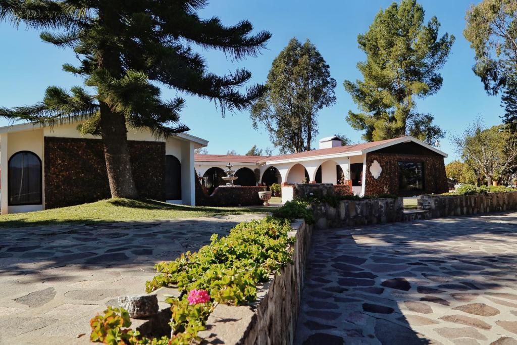 a villa with a garden and a building at Rancho el Parral in San Marcos