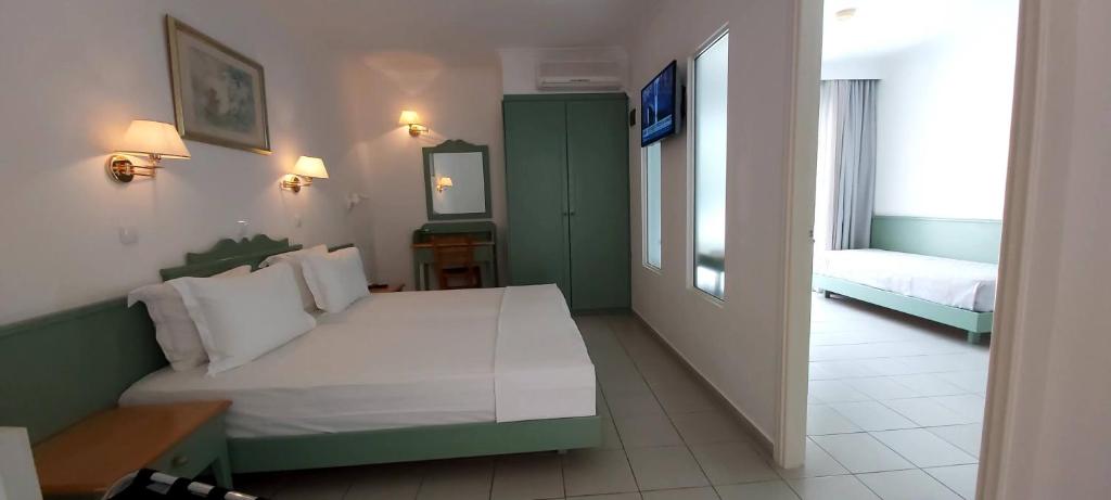 Postel nebo postele na pokoji v ubytování Andromeda Hotel Apartments