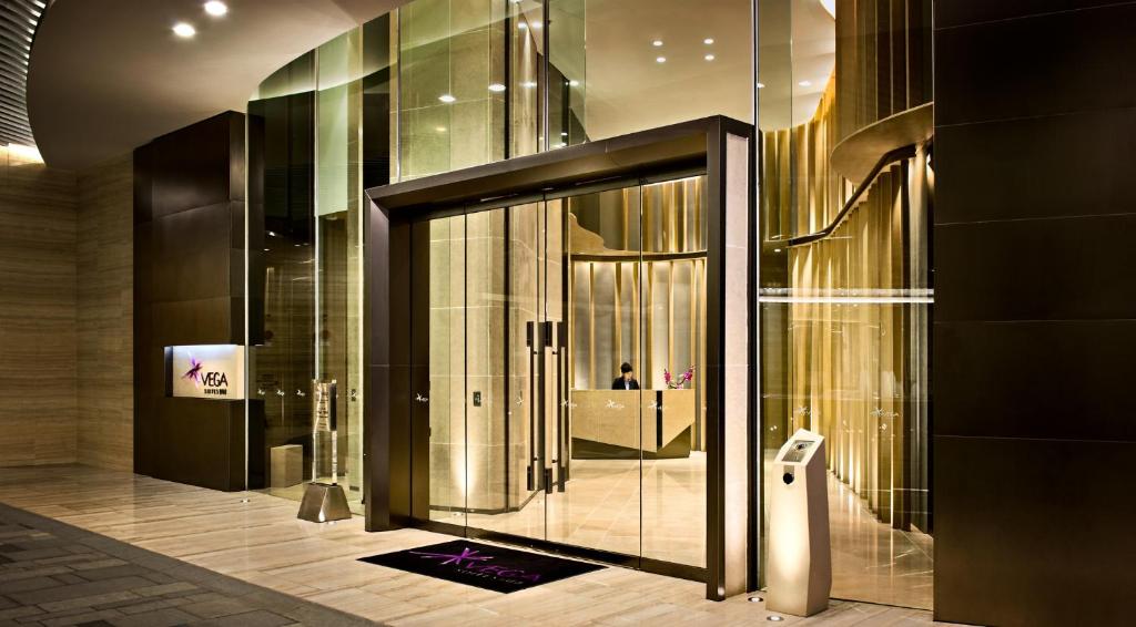 een lobby met een glazen deur in een gebouw bij Vega Suites in Hong Kong