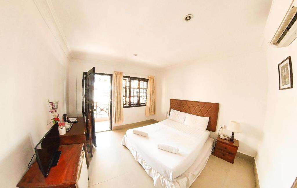 Postel nebo postele na pokoji v ubytování Riverside Hotel Phnom Penh