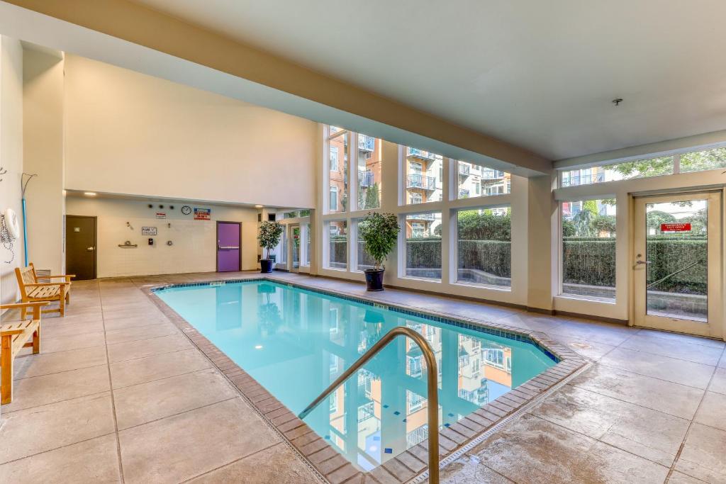 a large indoor swimming pool with windows at Belltown Court Sunset Suite in Seattle