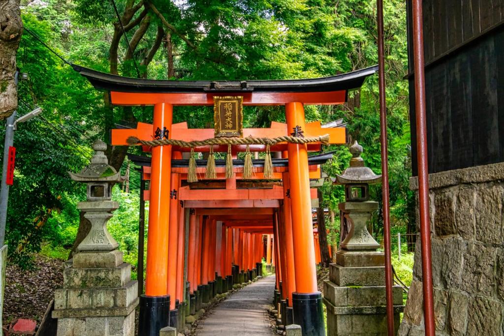 an entrance to an orange torii gate at One More Heart Fushimi Inari in Momoyama-chō