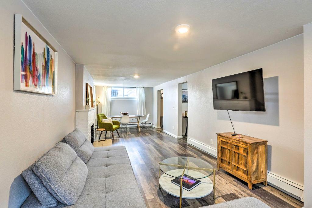 a living room with a couch and a tv at Centrally Located Denver Townhome Near Dtwn in Denver